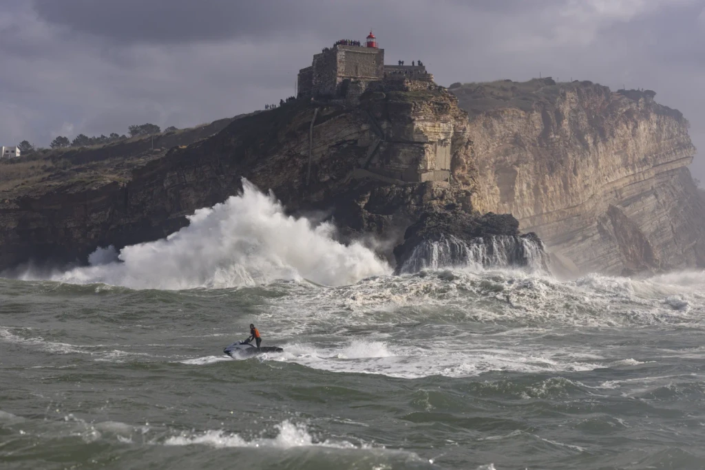 View from sea on a big cliff and a jet ski in nazare