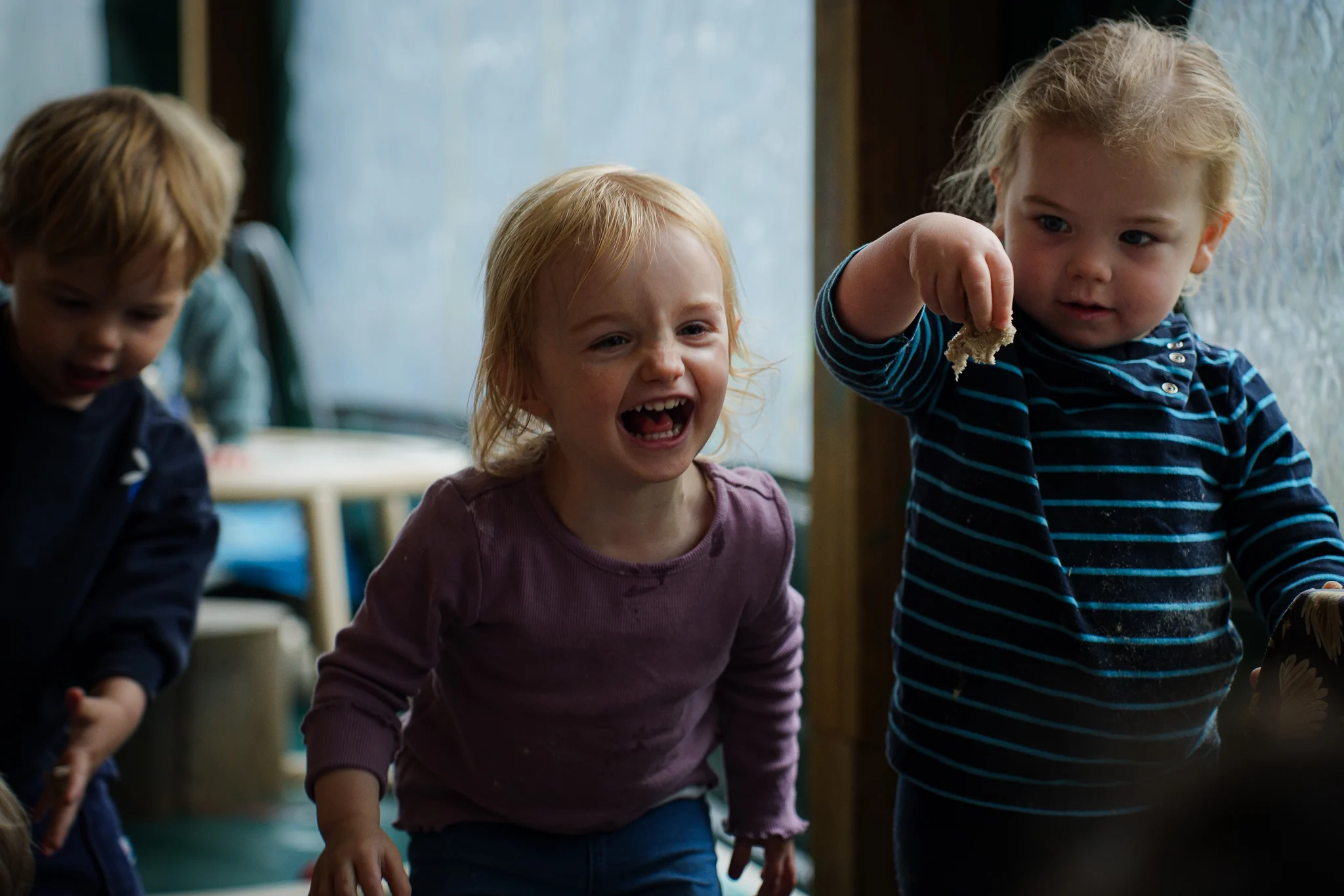 A teacher reading an illustrated book with young children during group time.