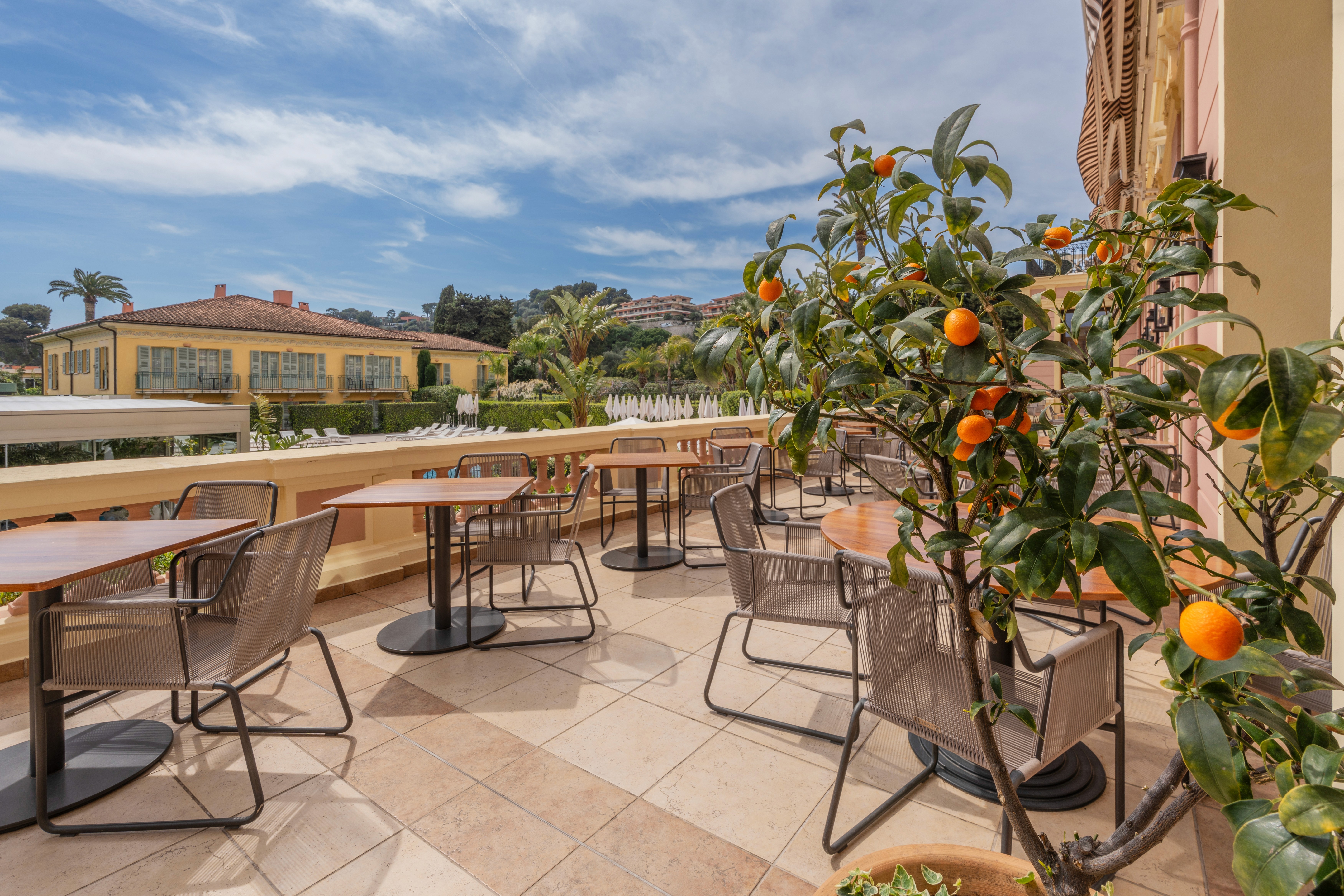 Hotel terrace with citrus trees and outdoor dining at Royal Riviera Hotel, Saint-Jean-Cap-Ferrat