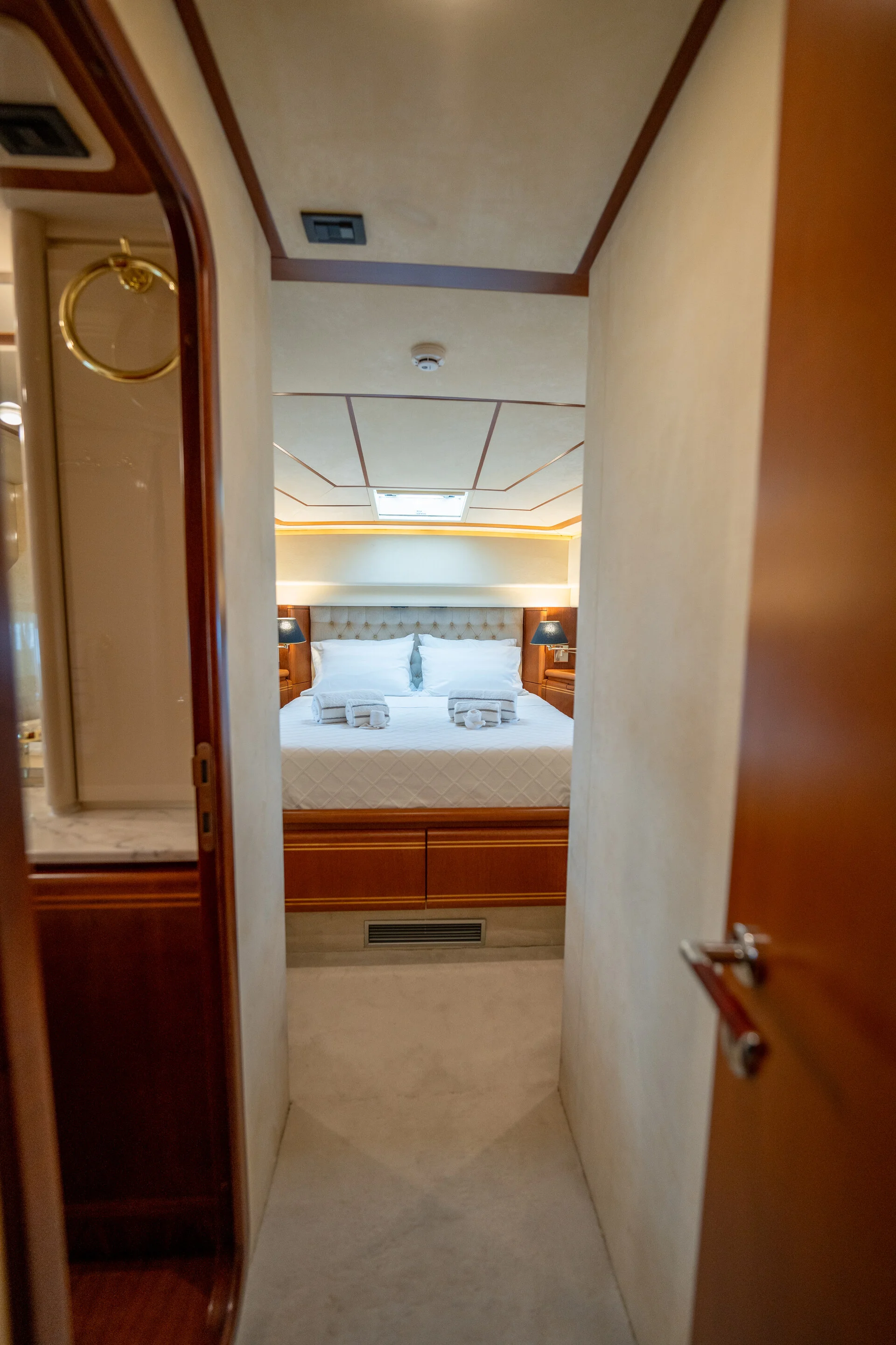 White Rock 36 speedboat with captain at helm cruising calm blue waters near Paros coastline with hills in background.