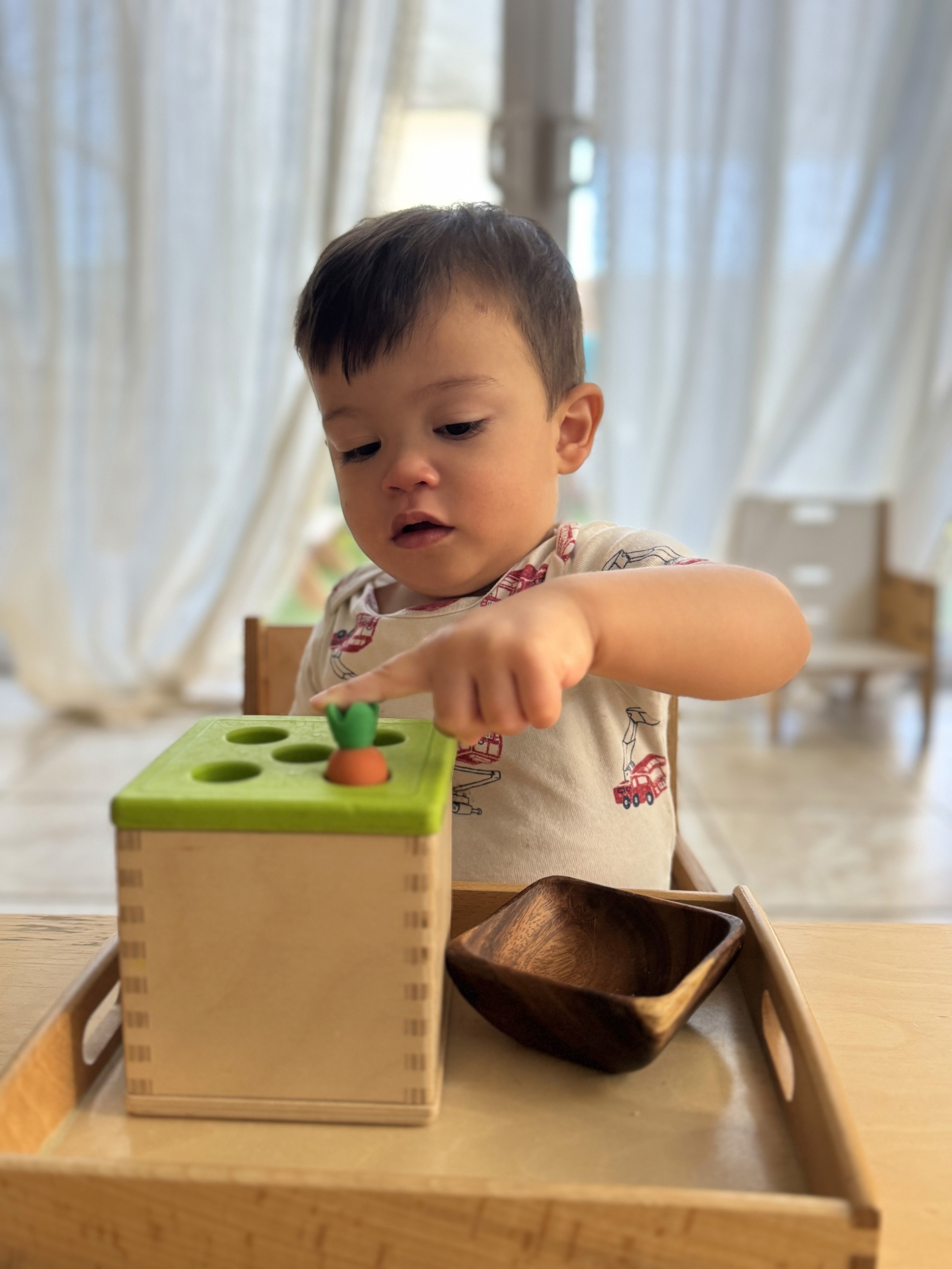 Montessori infant practicing fine motor skills in in-home Montessori classroom in Irvine CA
