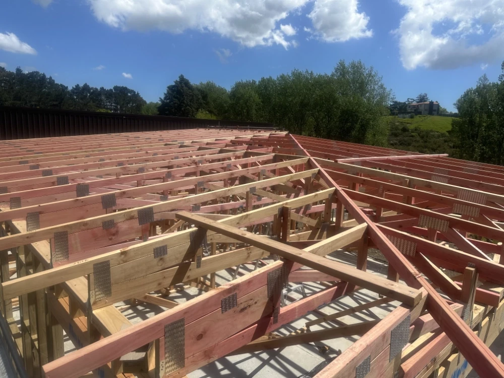 framing for roof area of new build, overlooking rolling green hills, East Auckland