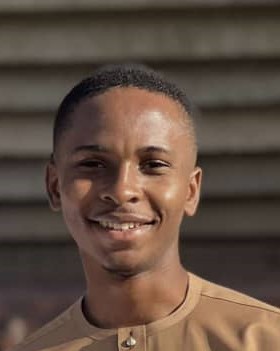 woman staring directly at camera near pink wall