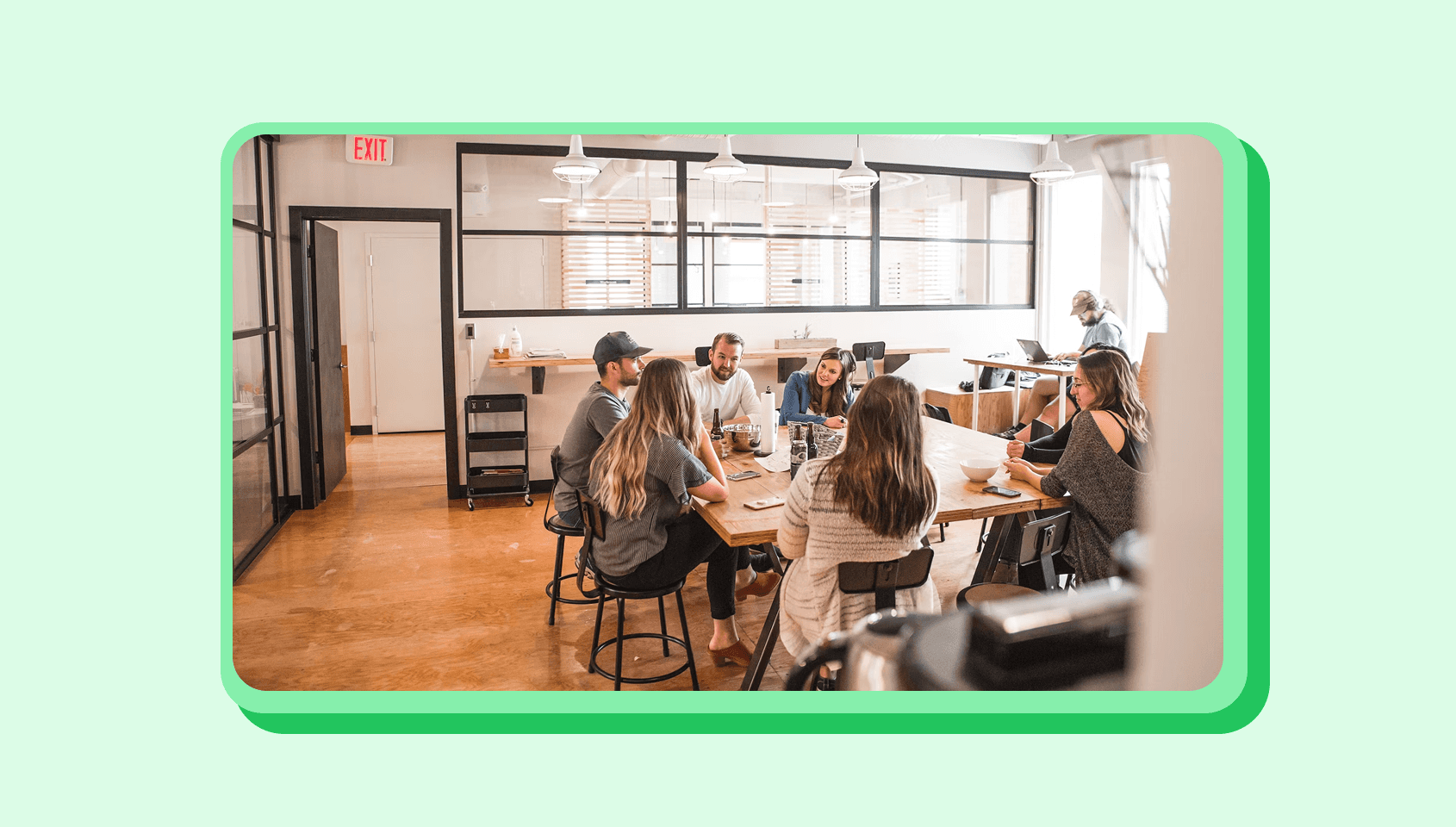 A half dozen people chat with each other in a meeting.