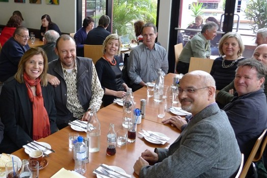 A photo of a group of people sitting at a table in a restaurant.