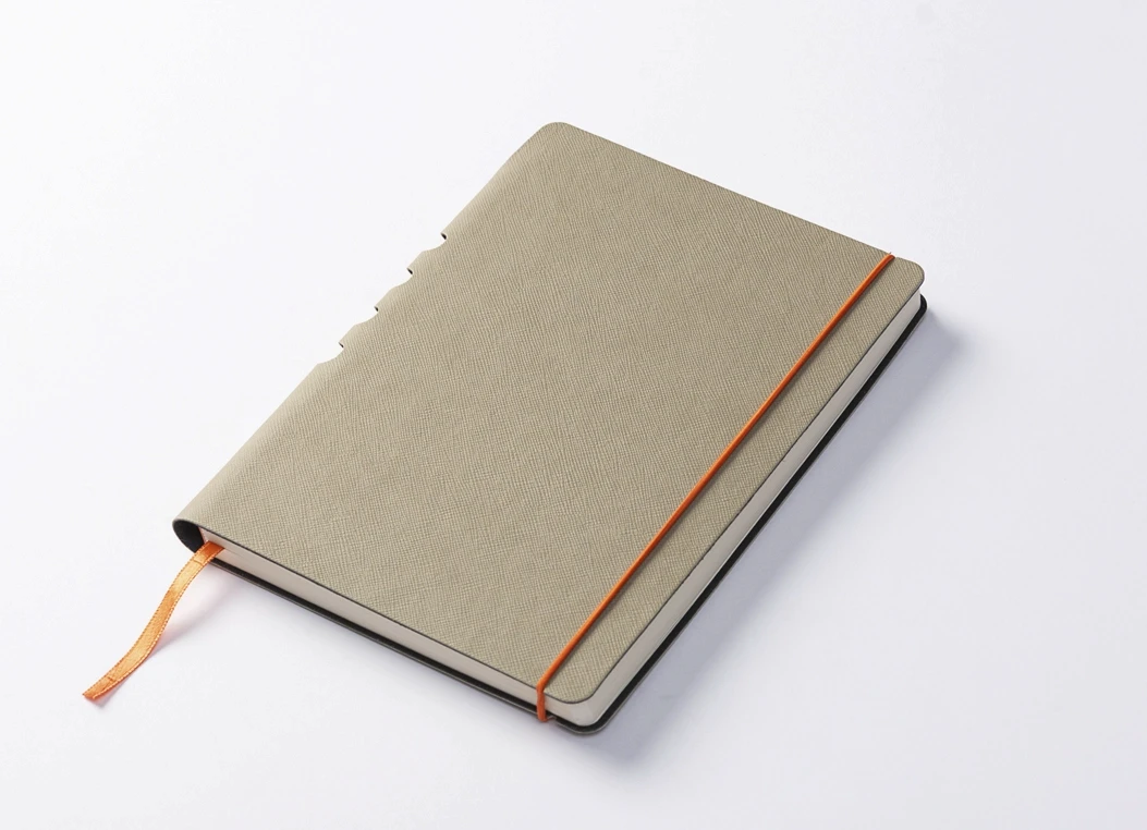 Textured fabric journal closed with vertical elastic band