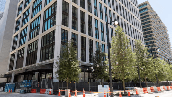 Exterior view of Water Street Tampa Phase 2 building facade showing modern architecture with ground floor retail and landscaping