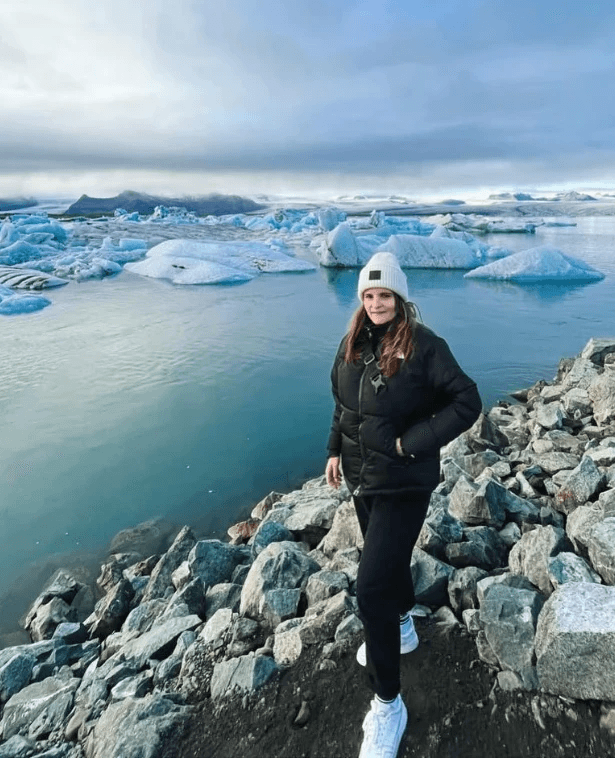 Standing in from of iceberg in Iceland