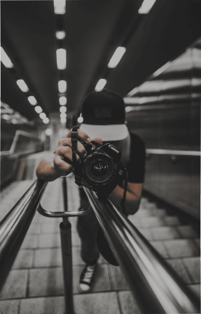 man holidng a camera