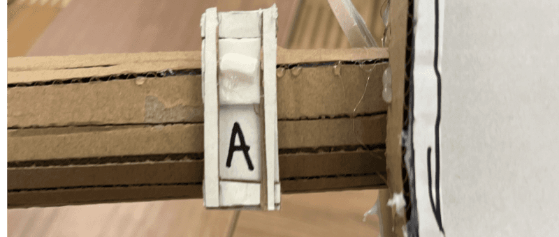 Cardboard autonomy toggle to the left of the dashboard screen on the bike handle