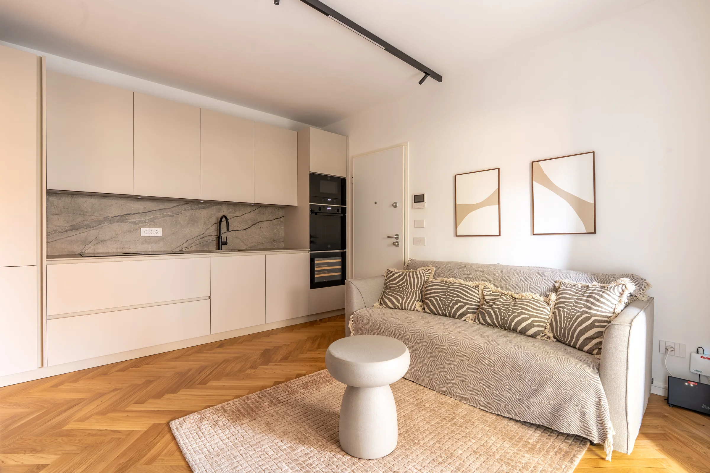 Minimal living room in neutral tones — Province of Imperia, Italy. Photography by Yunes Calore.