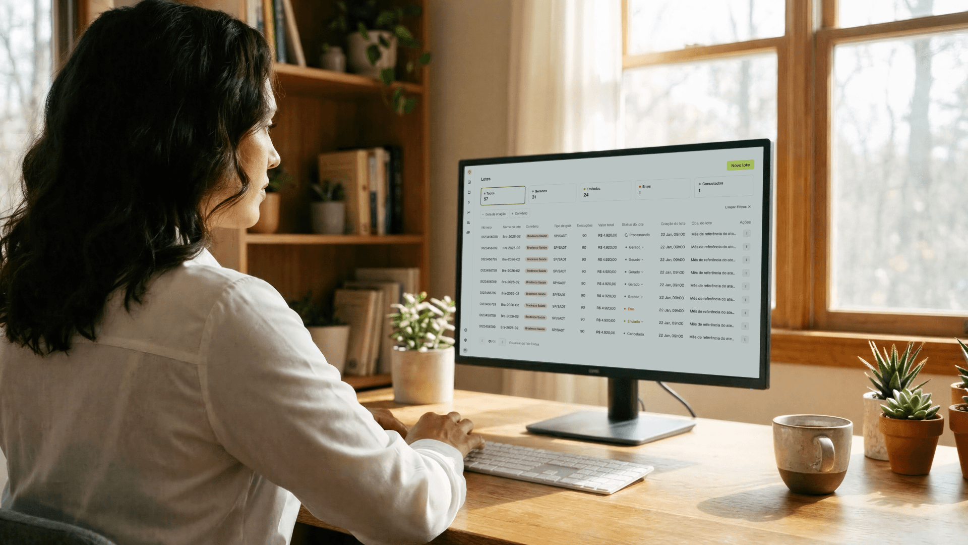Profissional de saúde utilizando a plataforma Tivita em um monitor desktop, visualizando a tela de lotes de guias com status de processamento, envio e cancelamento, funcionalidade que facilita o faturamento de clínicas integradas a convênios médicos