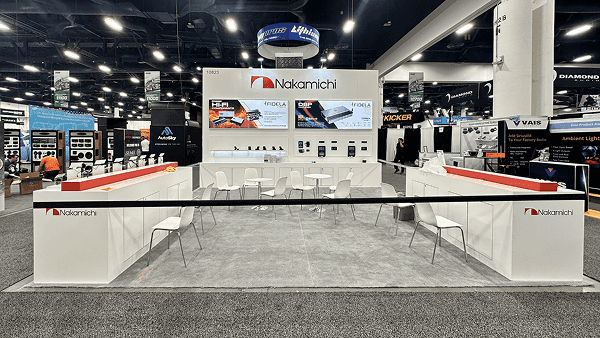 Angled view of a 20x20 SEMA booth with aftermarket product grouping, clear wall hierarchy, and direct aisle-facing presentation