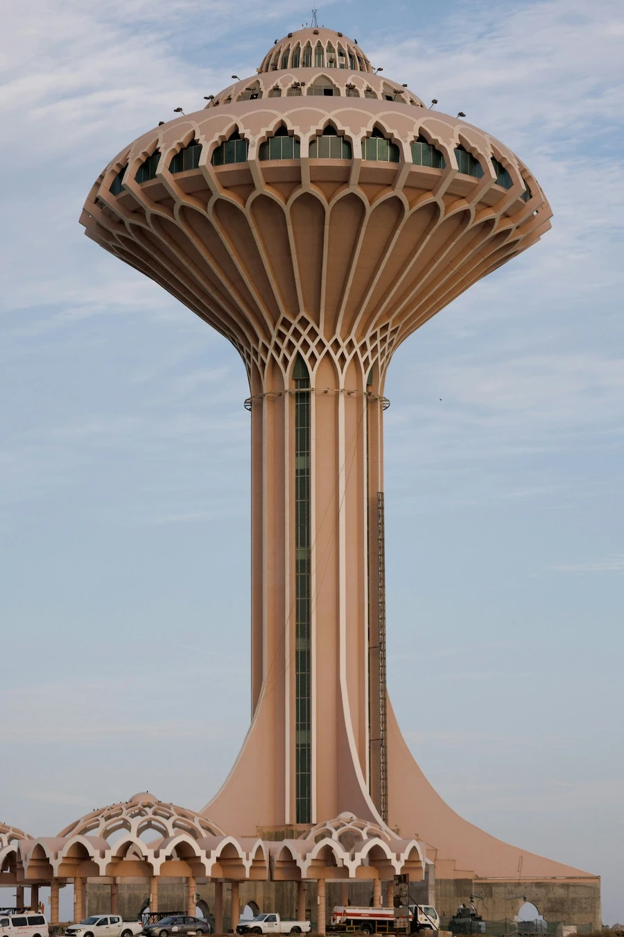 Al Khobar Water Tower rising over the Gulf coast in Al Khobar, Saudi Arabia, against a pale sky.