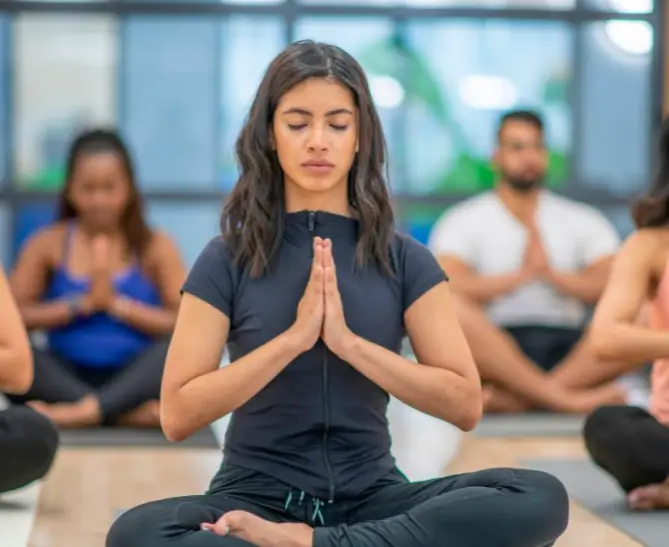 A group of people performing yoga