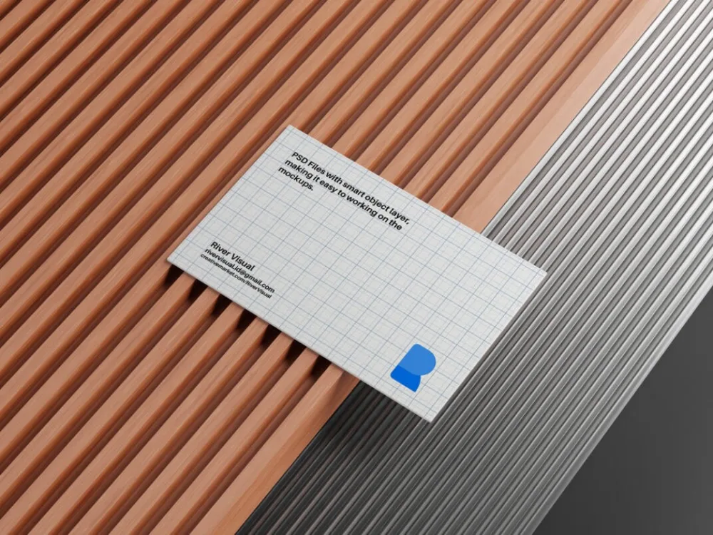 Business card mockup with a grid design and minimalist layout, placed on a surface combining warm wooden slats and sleek metallic ridges. The setting highlights contrasting textures and modern aesthetics.
