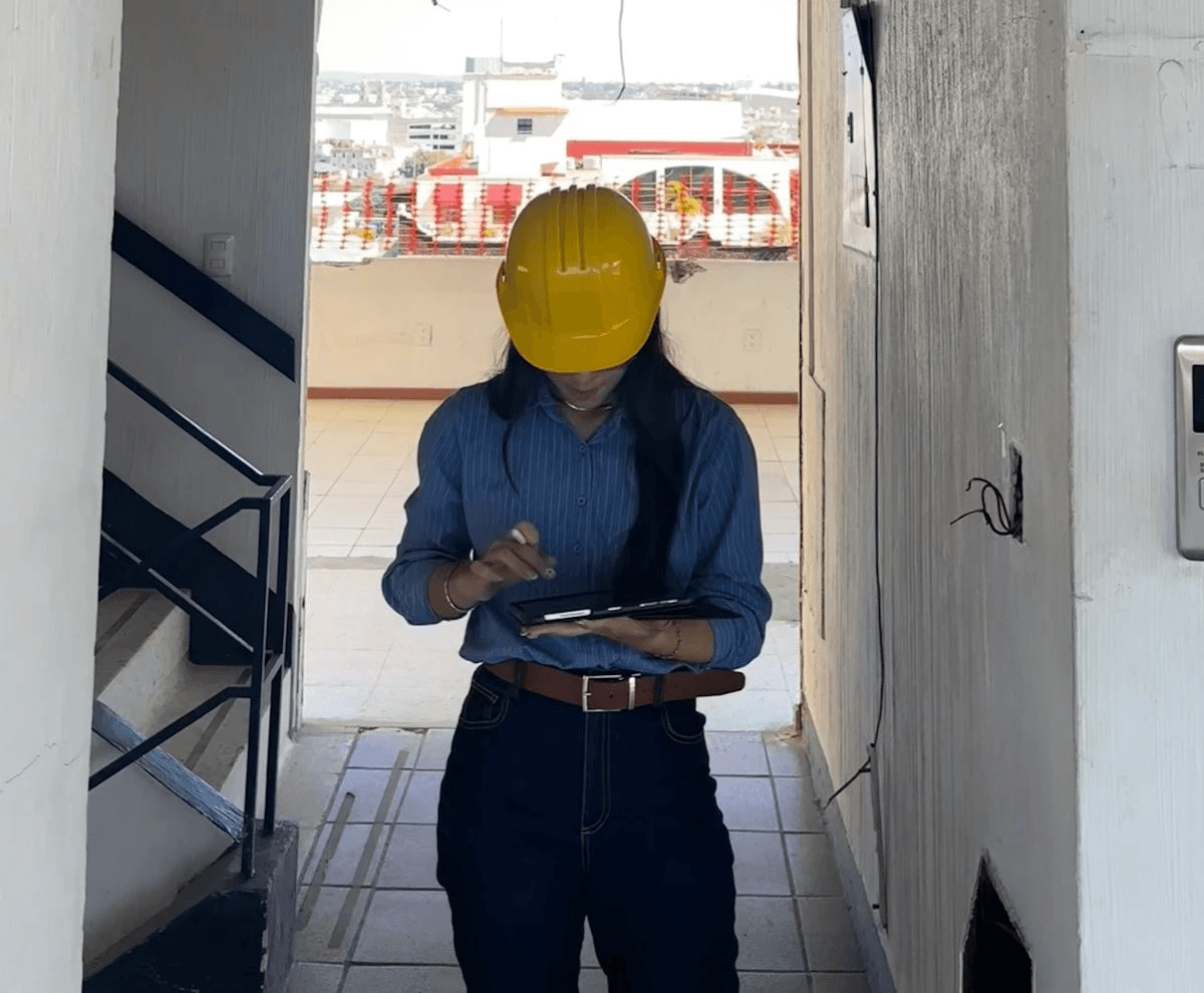 person in blue long sleeve shirt holding brown and black bird