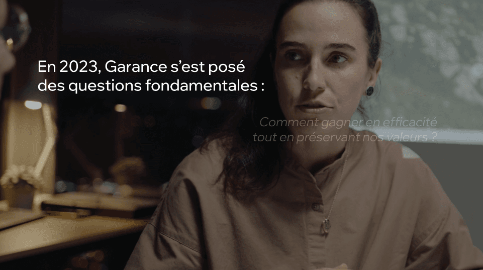 Snow-covered mountain peaks cast in shadow, illuminated by soft sunlight. The sky is clear, evoking a serene and majestic atmosphere.