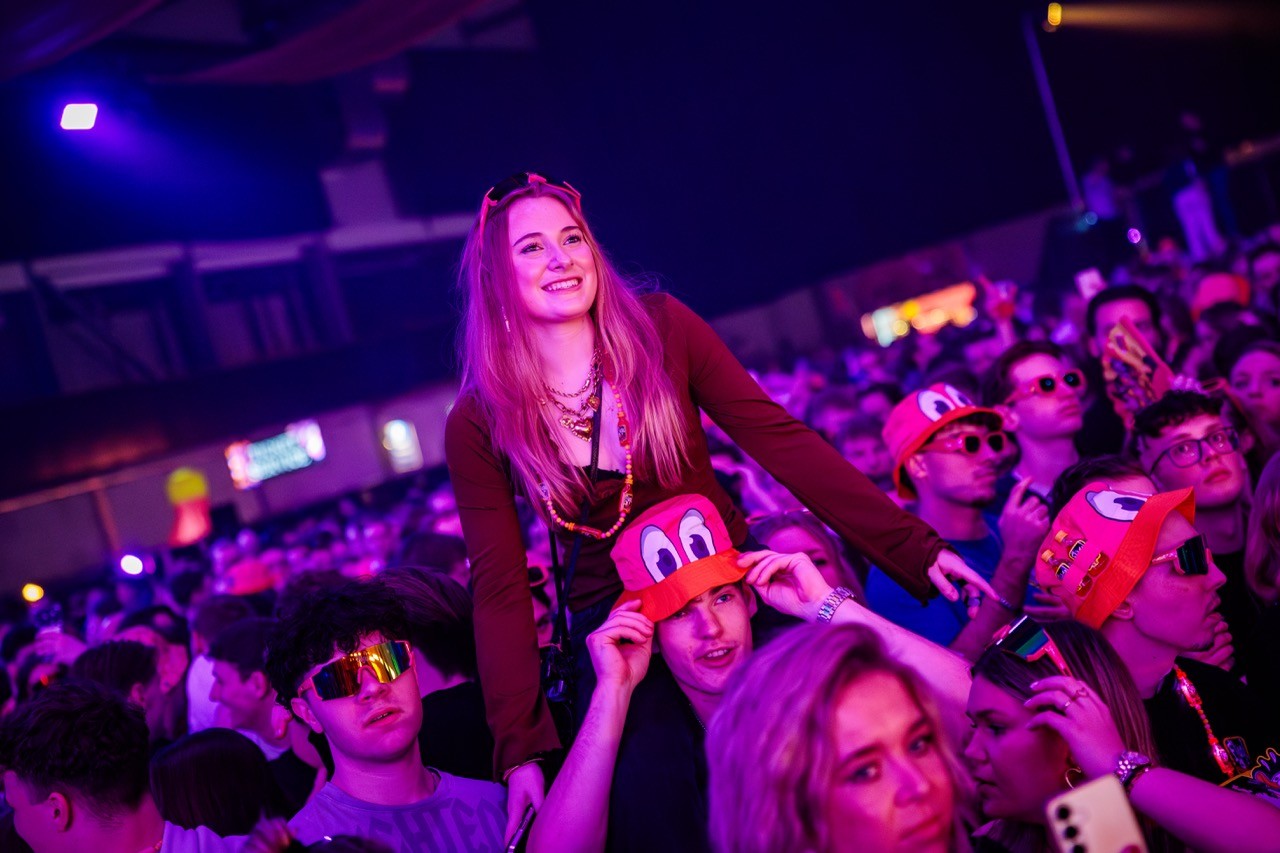 woman dancing on shoulders at music festival
