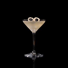 A closeup of a Saketini drink against a dark background.