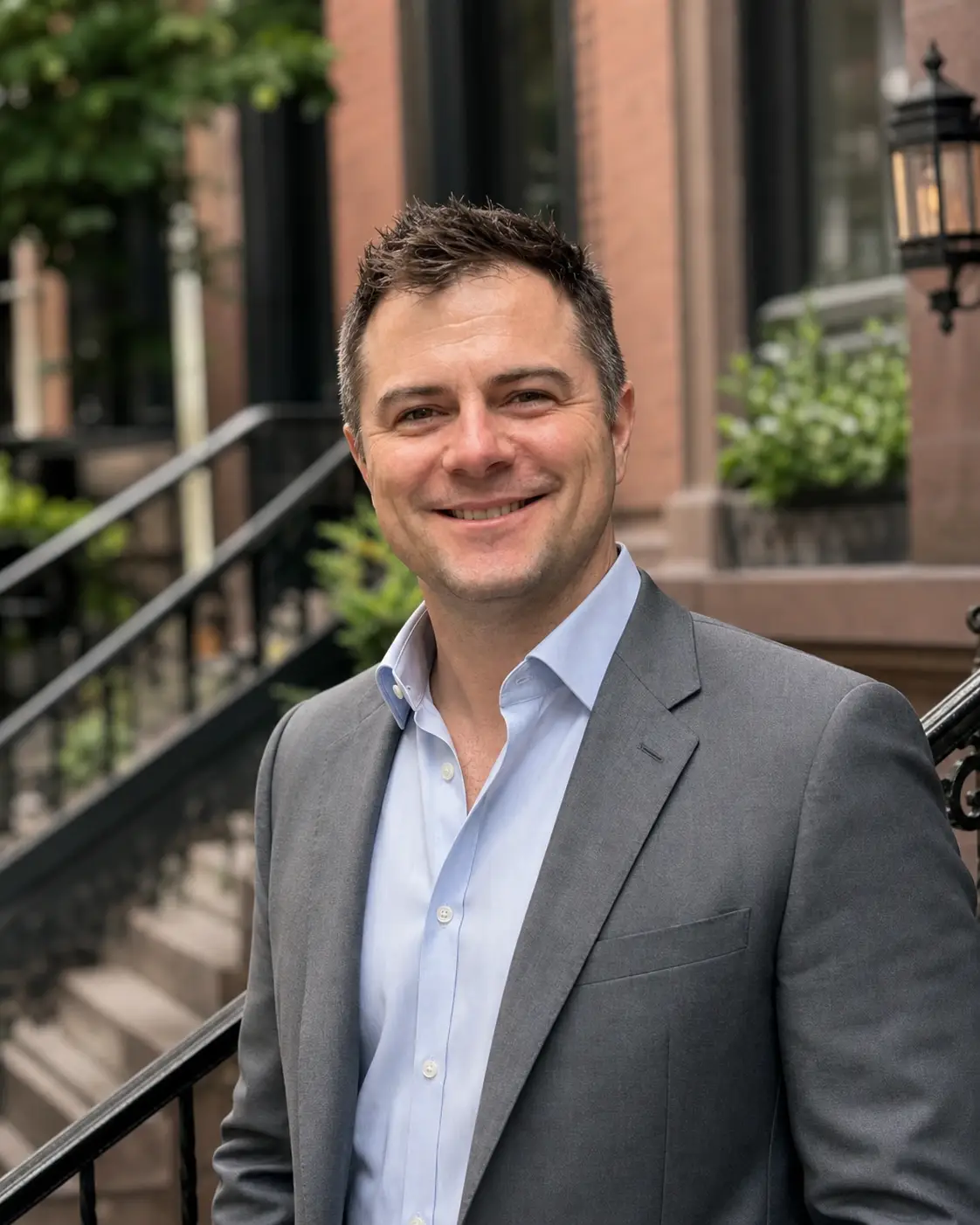 John-Scott Johnson of BRN Partners, a white man with short brown hair wearing a light blue button down shirt with a grey blazer