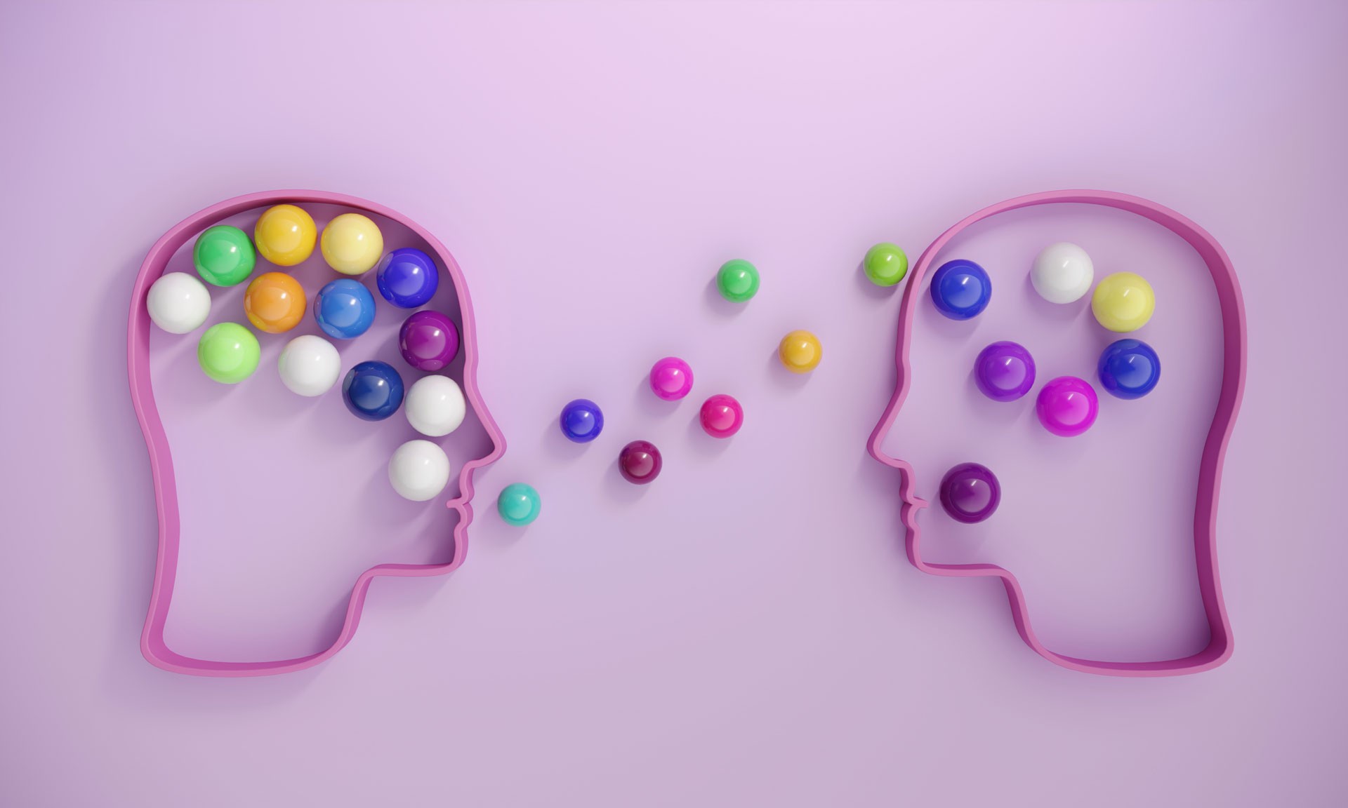 Human heads includes lots of multi colored spheres, symbolizing communication concepts