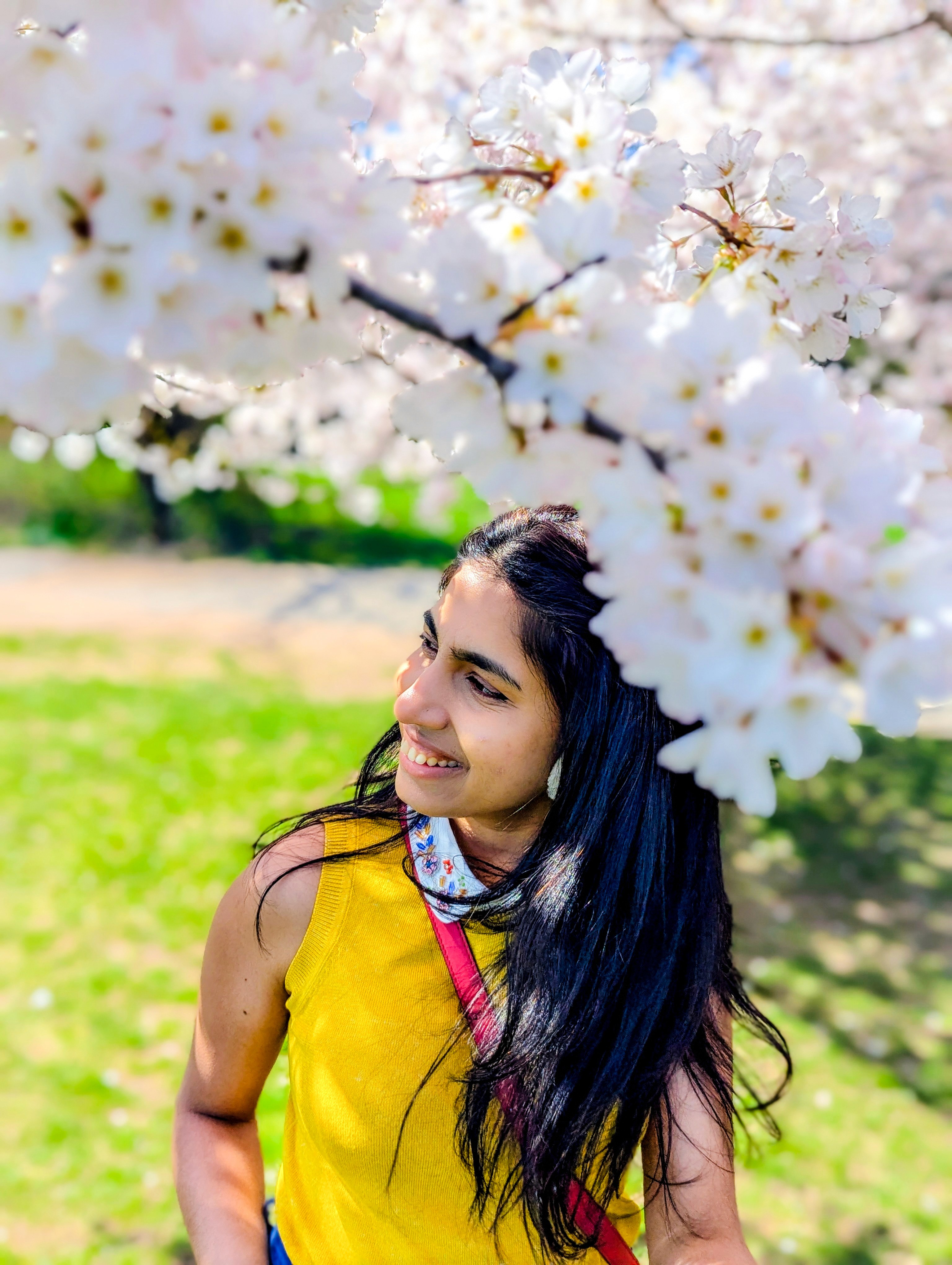 Portrait of man looking to the left and smiling with a dark background