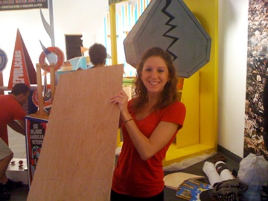 student preparing installations for The Candy Coated Carnival of Controversy