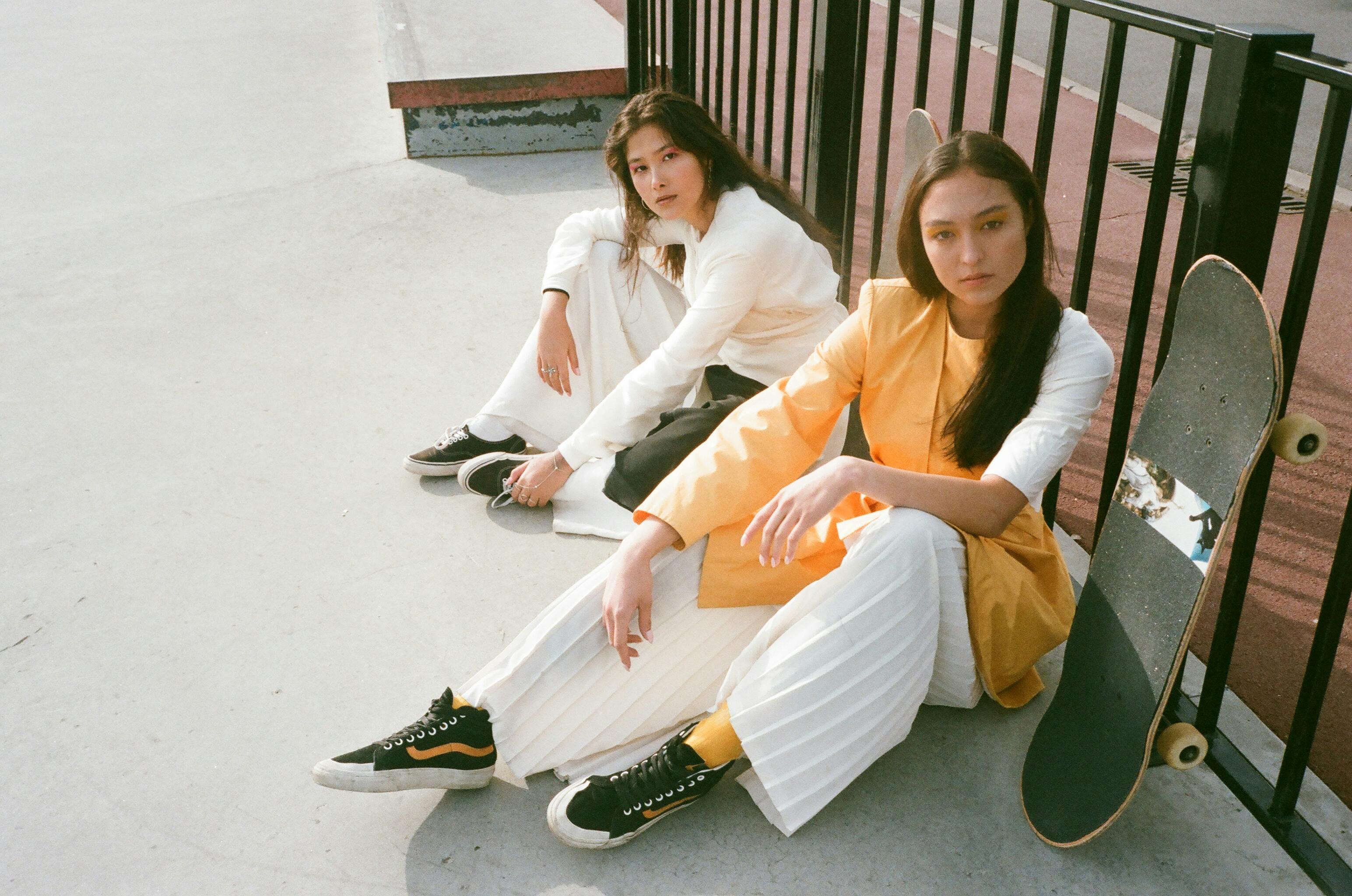 Female skateboarders sitting on the ground