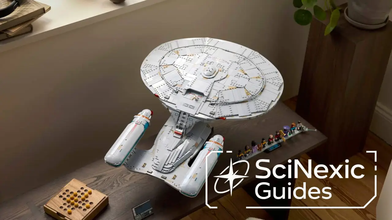 A detailed model of a futuristic starship is displayed on a table top beside a row of small figurines in a well-lit room, with a sign reading "SciNexic Guides" in the lower right corner.