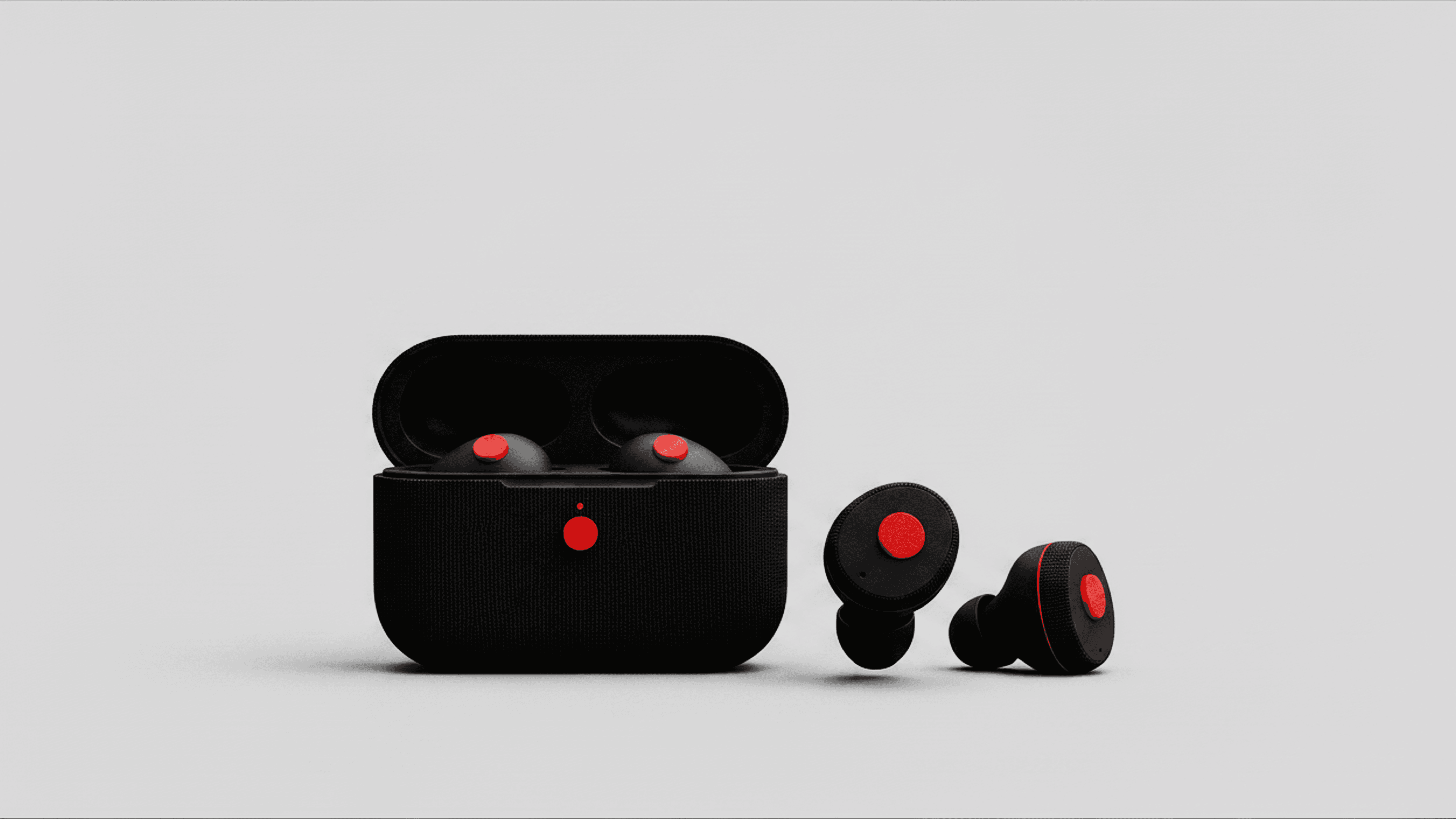 Compact black wireless earbuds with red circular detailing, displayed alongside their open charging case on a minimalist surface.