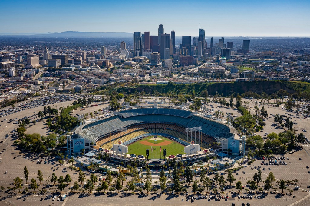an aerial view of a baseball stadium with a city in the background