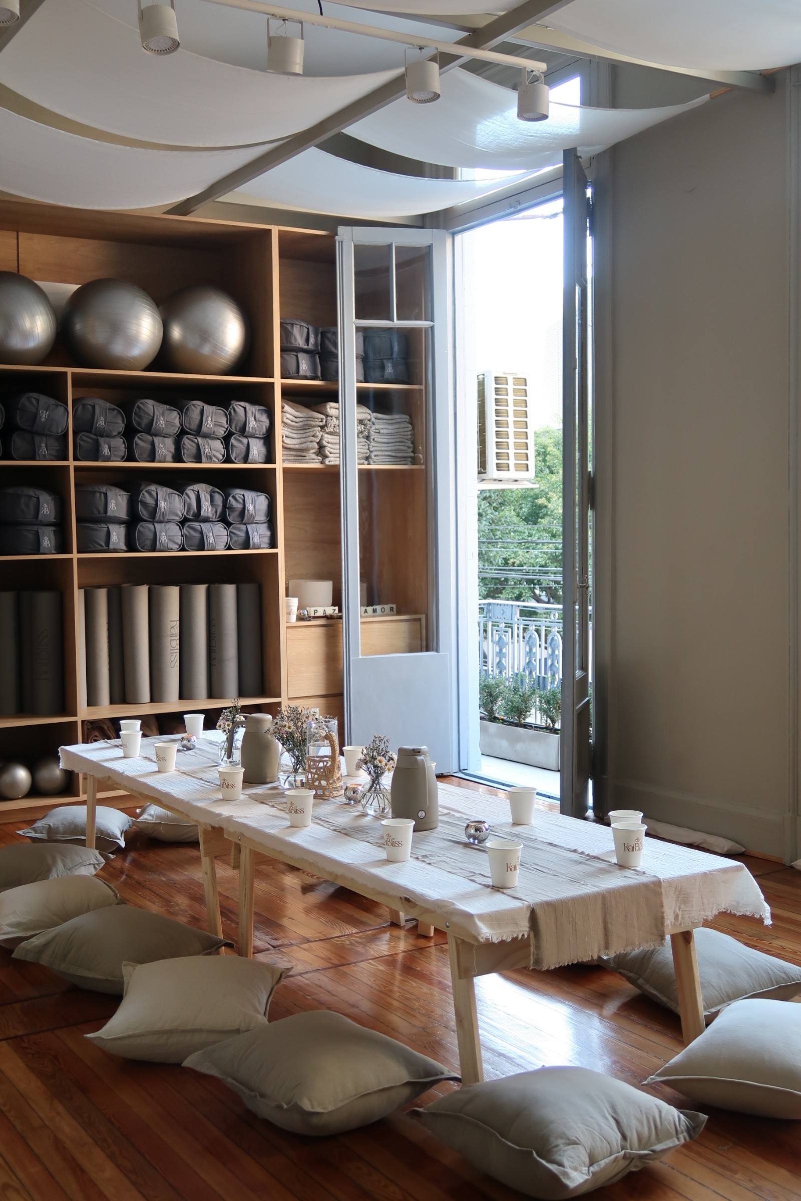 Aerial yoga pose with a woman leaning back in a hammock