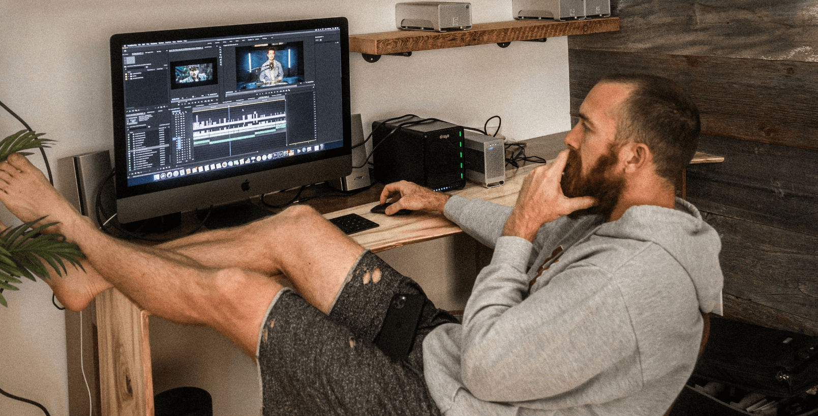 Man editing video at desk - Podcast Clips for Social Media
