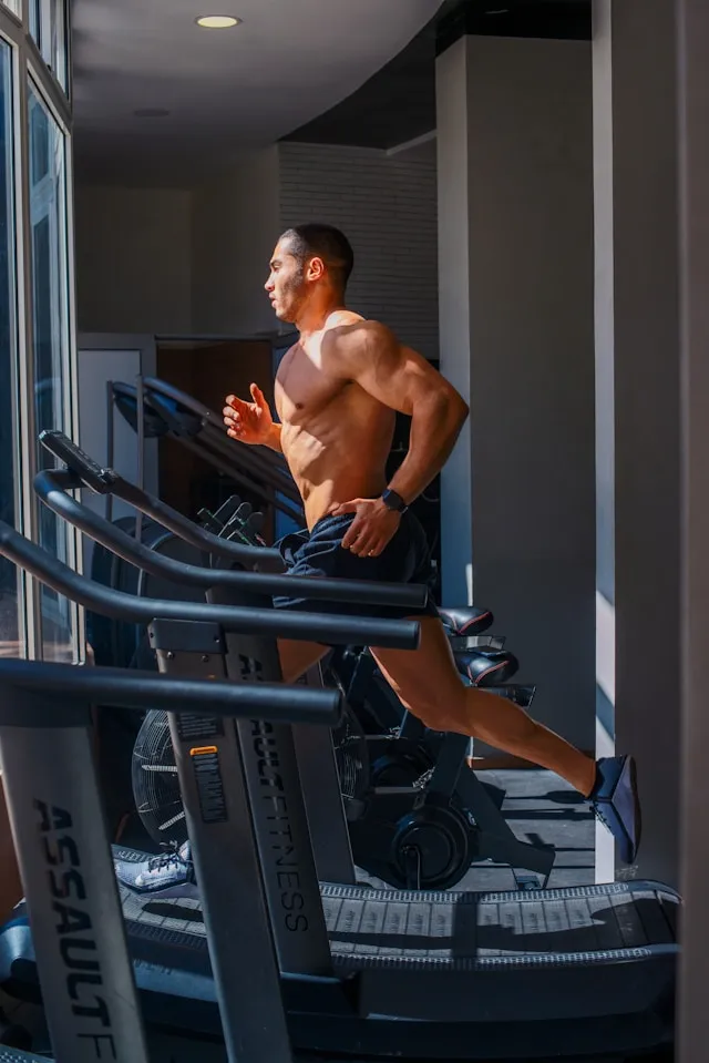 Man running on a treadmill indoors