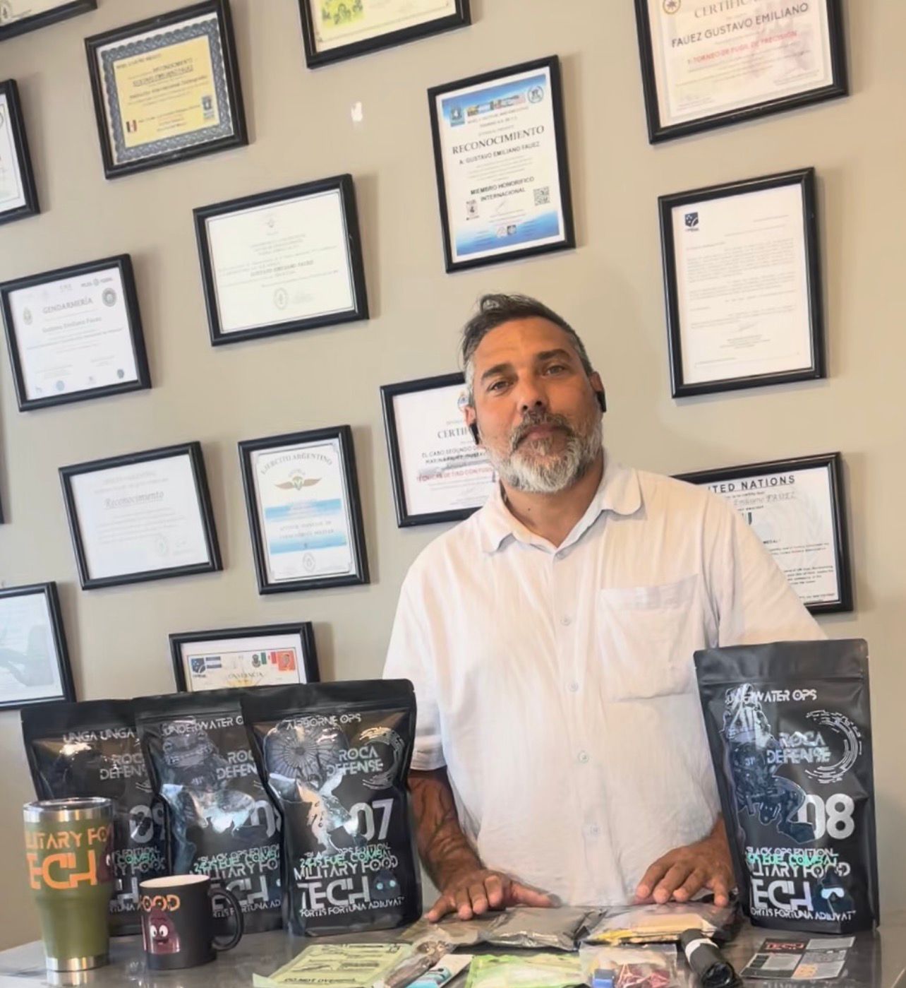 Professional headshot of a woman with short, wavy brown hair wearing a black blazer and white shirt.