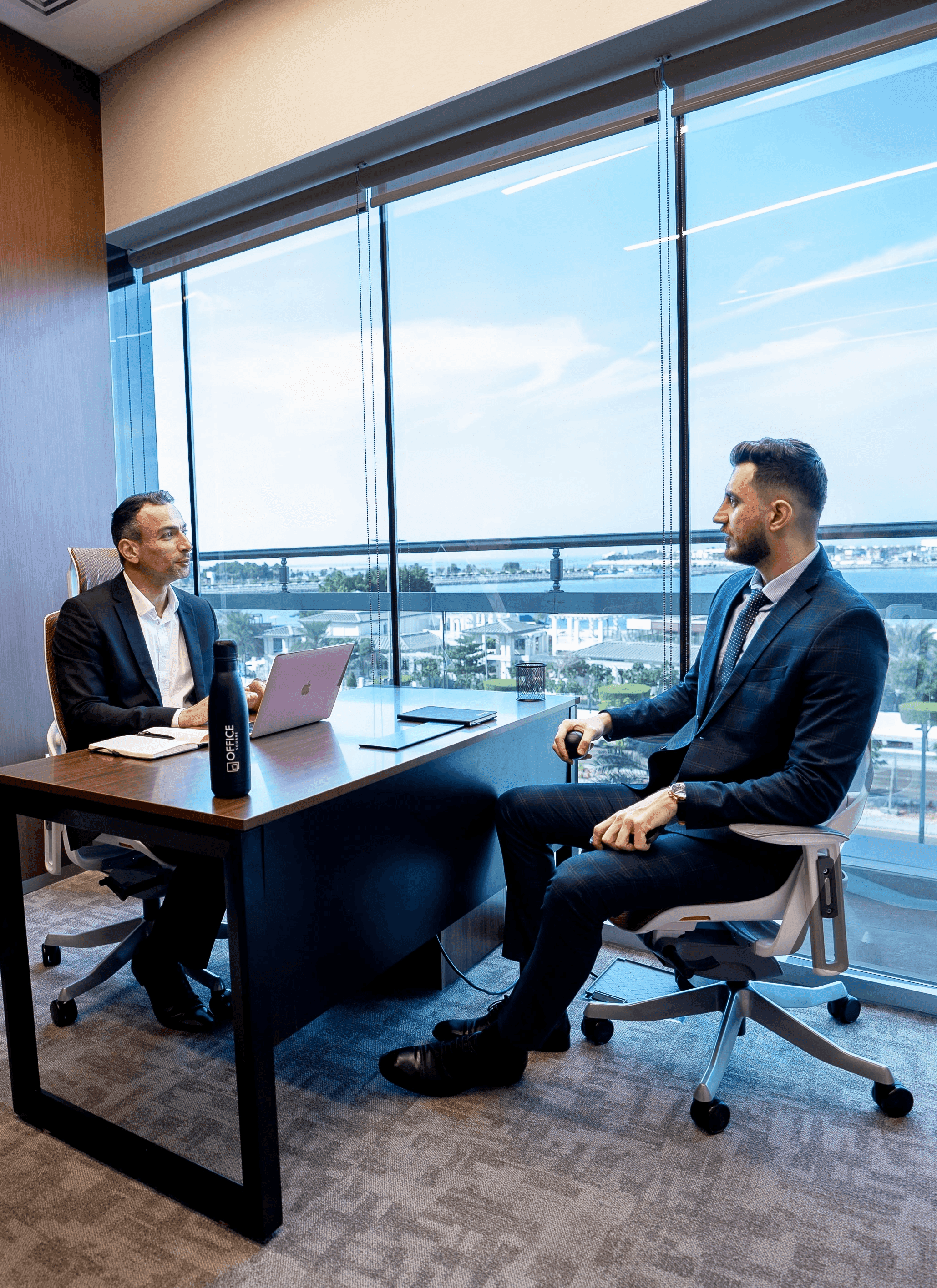 Coworking space at Nation Towers Mall featuring sleek wood interiors and modern ergonomic seating.