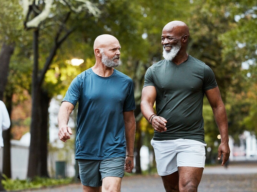 older men walking in a park to meet their adjusted step goal for weight loss