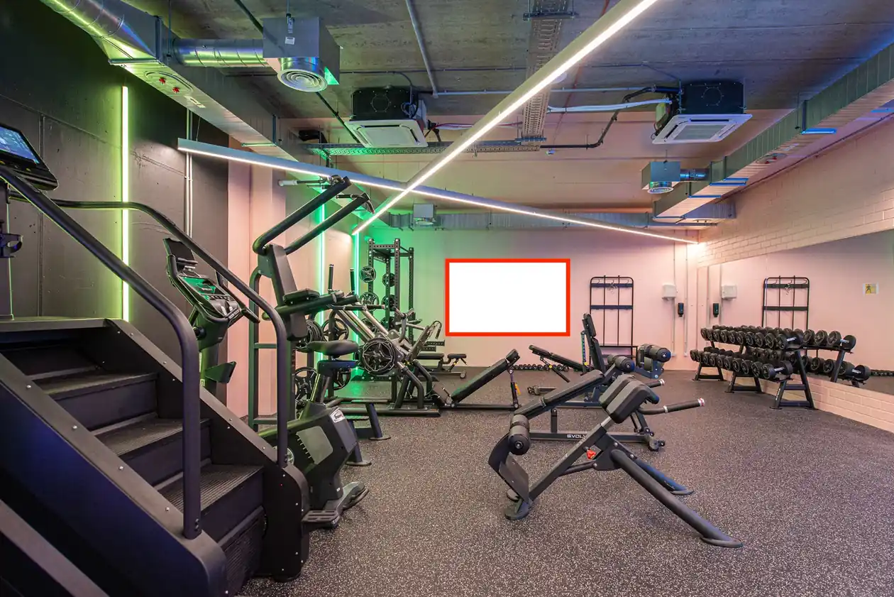 On-site gym in Vilnius student accommodation with cardio machines, weights and strength training equipment.