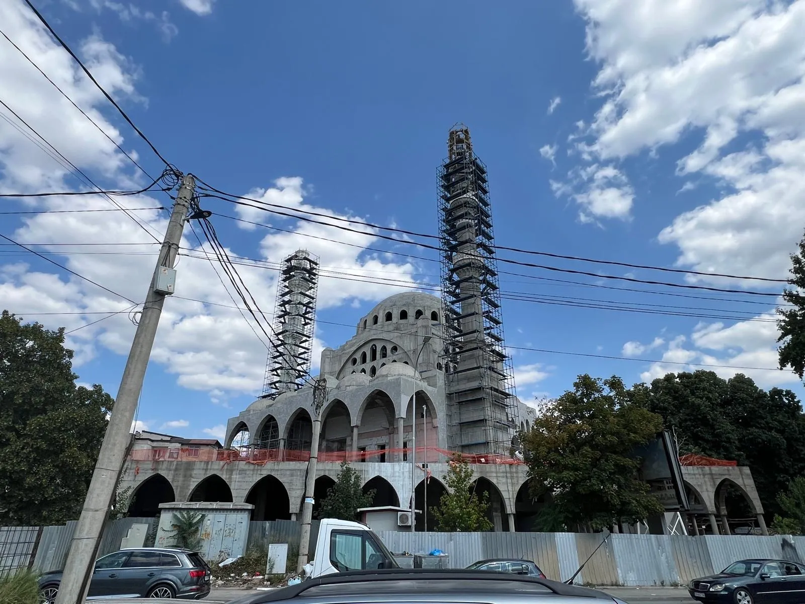 Mosque under construction in Skopje with scaffolding on the minaret and partially completed domes. Terraplan Partners provided project supervision.