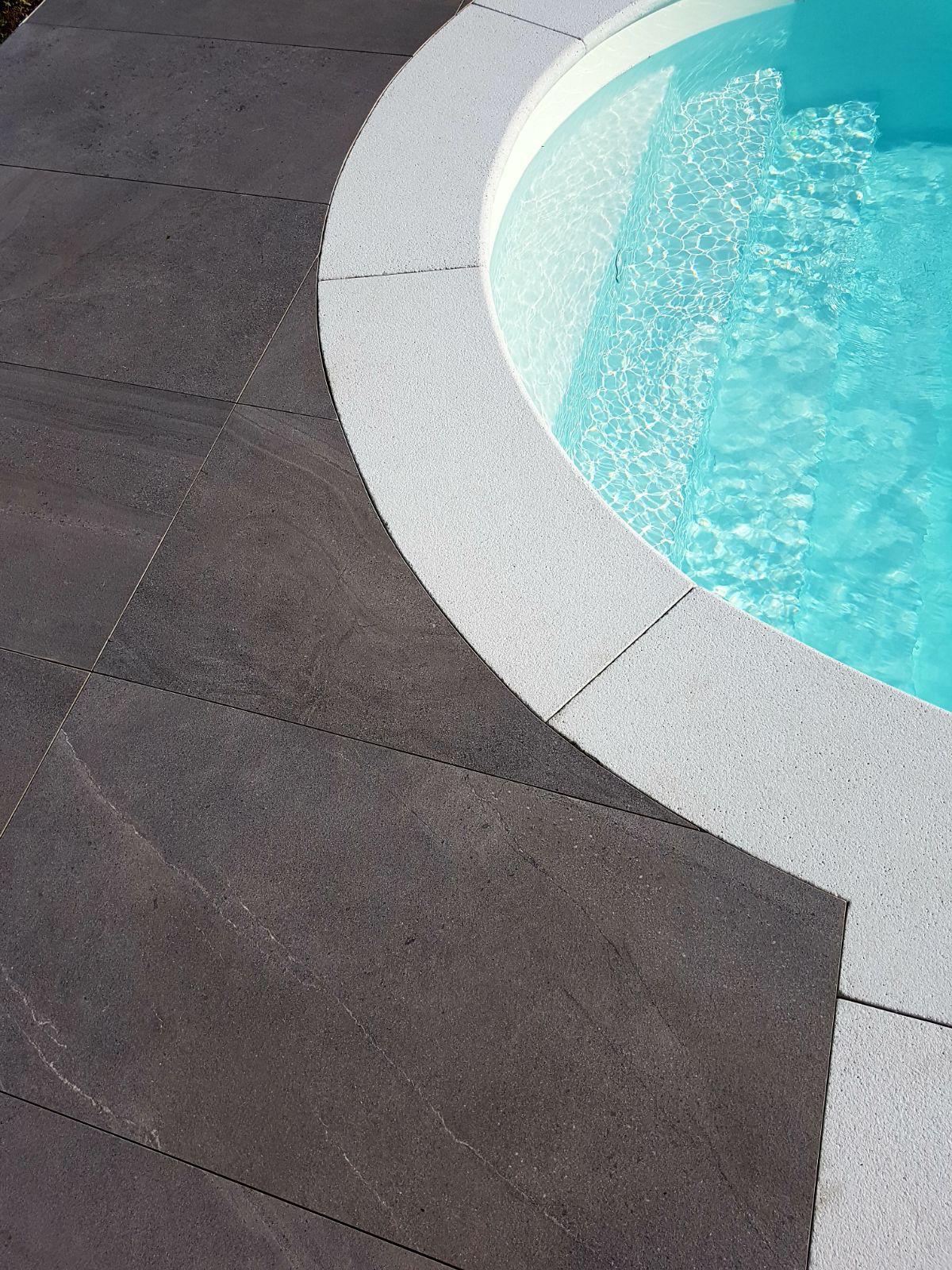 A modern architectural residence with a warm wooden facade and large glass balconies at dusk.