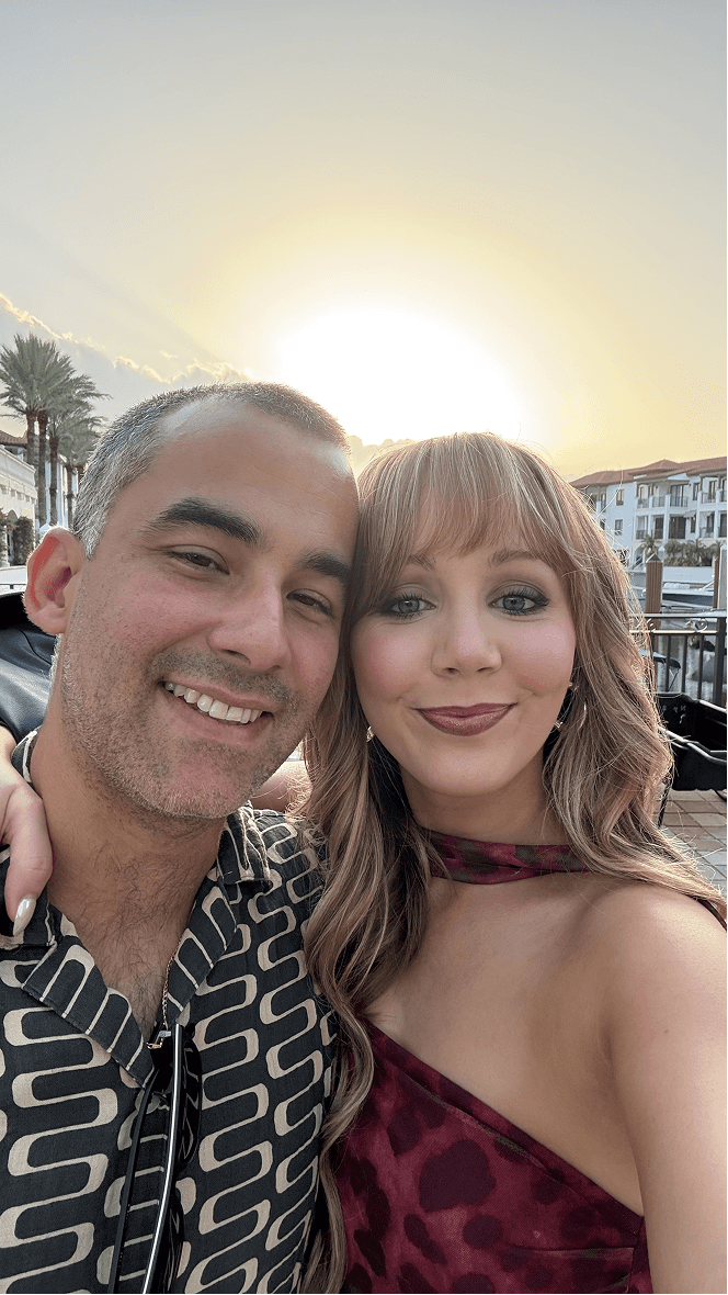 Couple portrait with dog on field