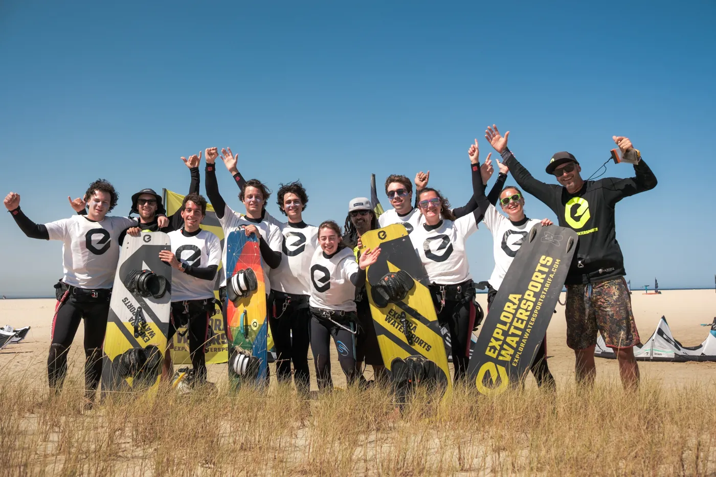 Kitesurfing lessons in Tarifa with Explora Watersports group of students and instructor on the beach