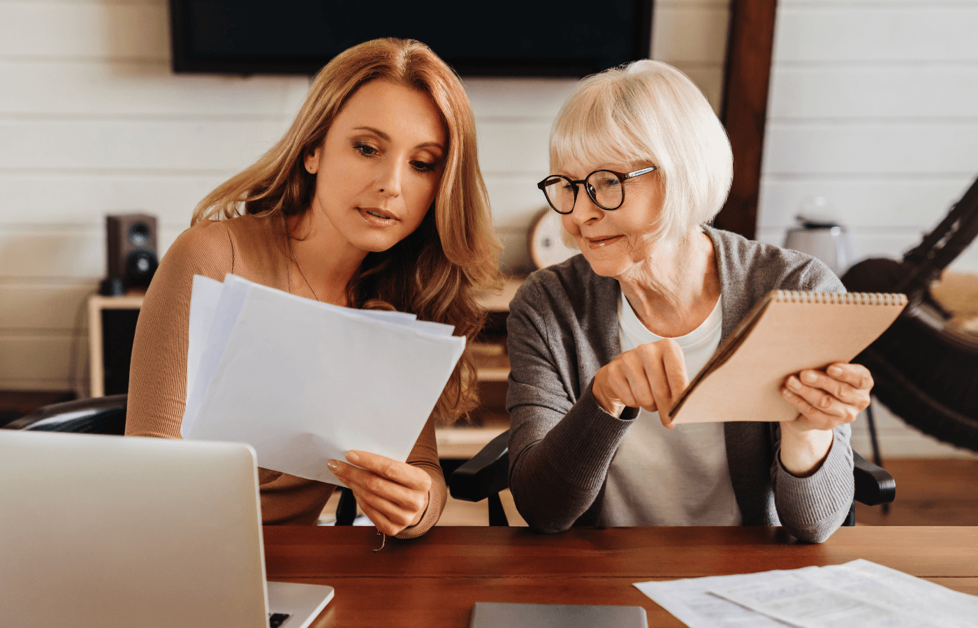 woman explaining some documentation to parent at home