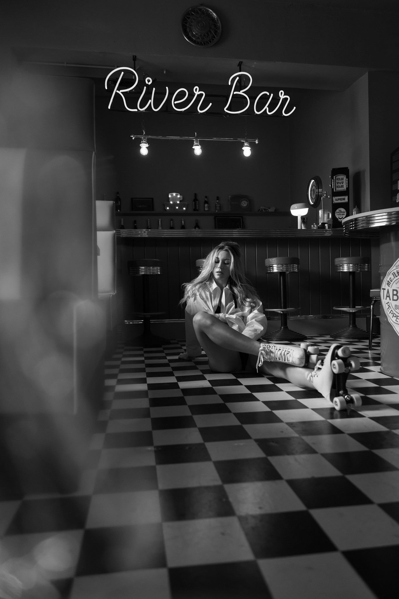 Agnieszka Czyzkowska fine art photography Warsaw woman on floor roller skates River Bar neon black and white