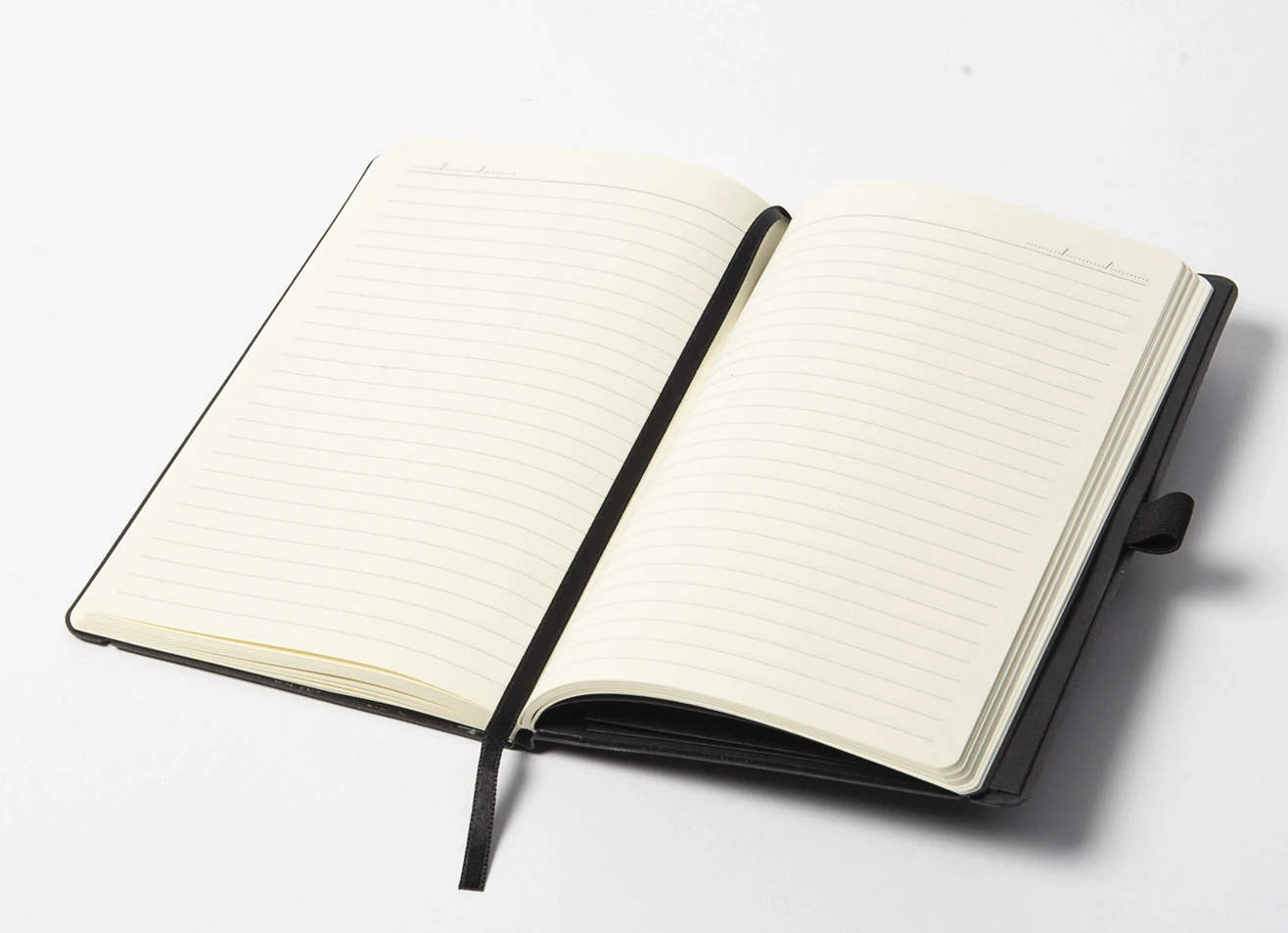 Open notebook displaying lined pages, date header, and black bookmark.
