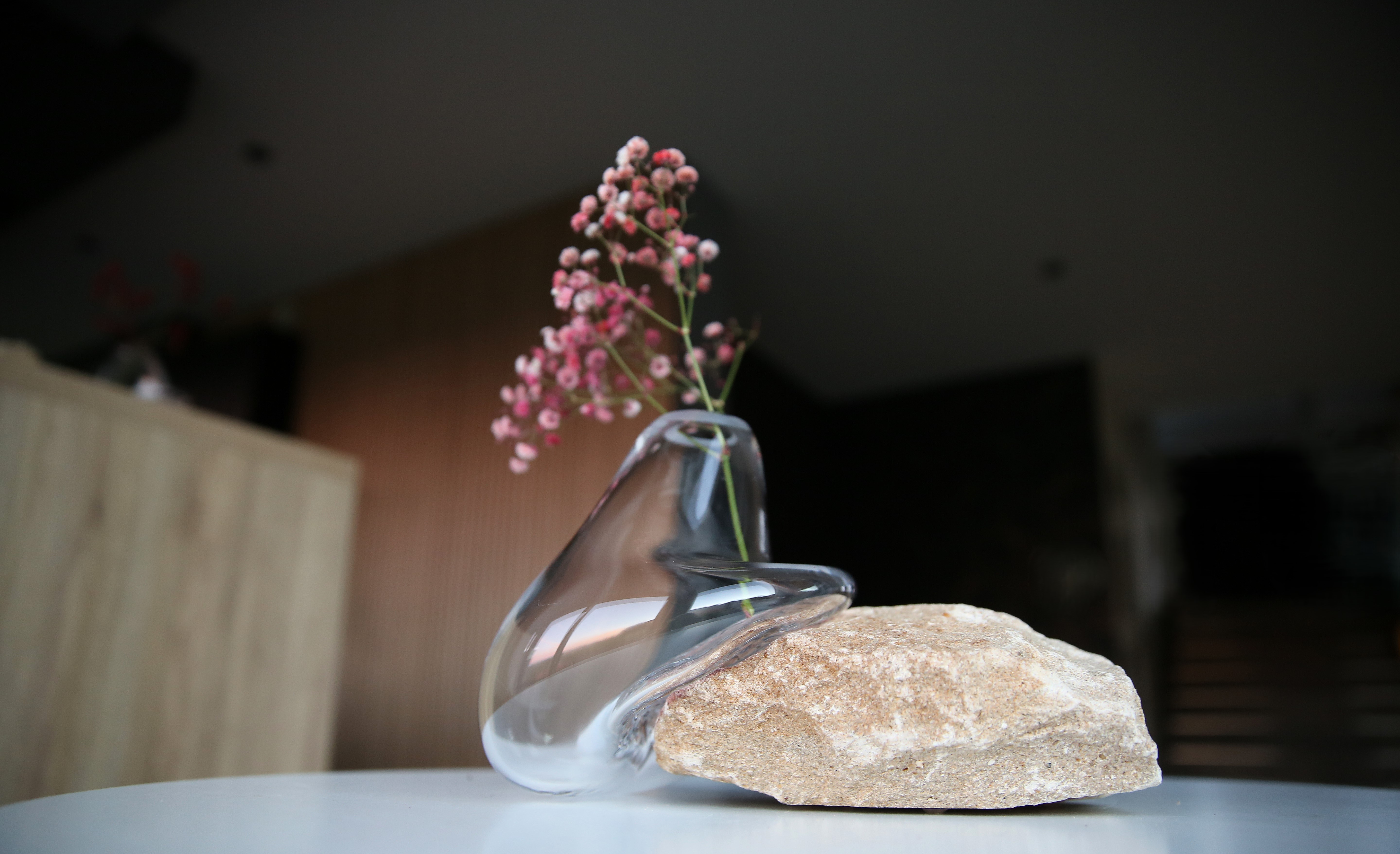 A moody scene of a room with a lamp shade