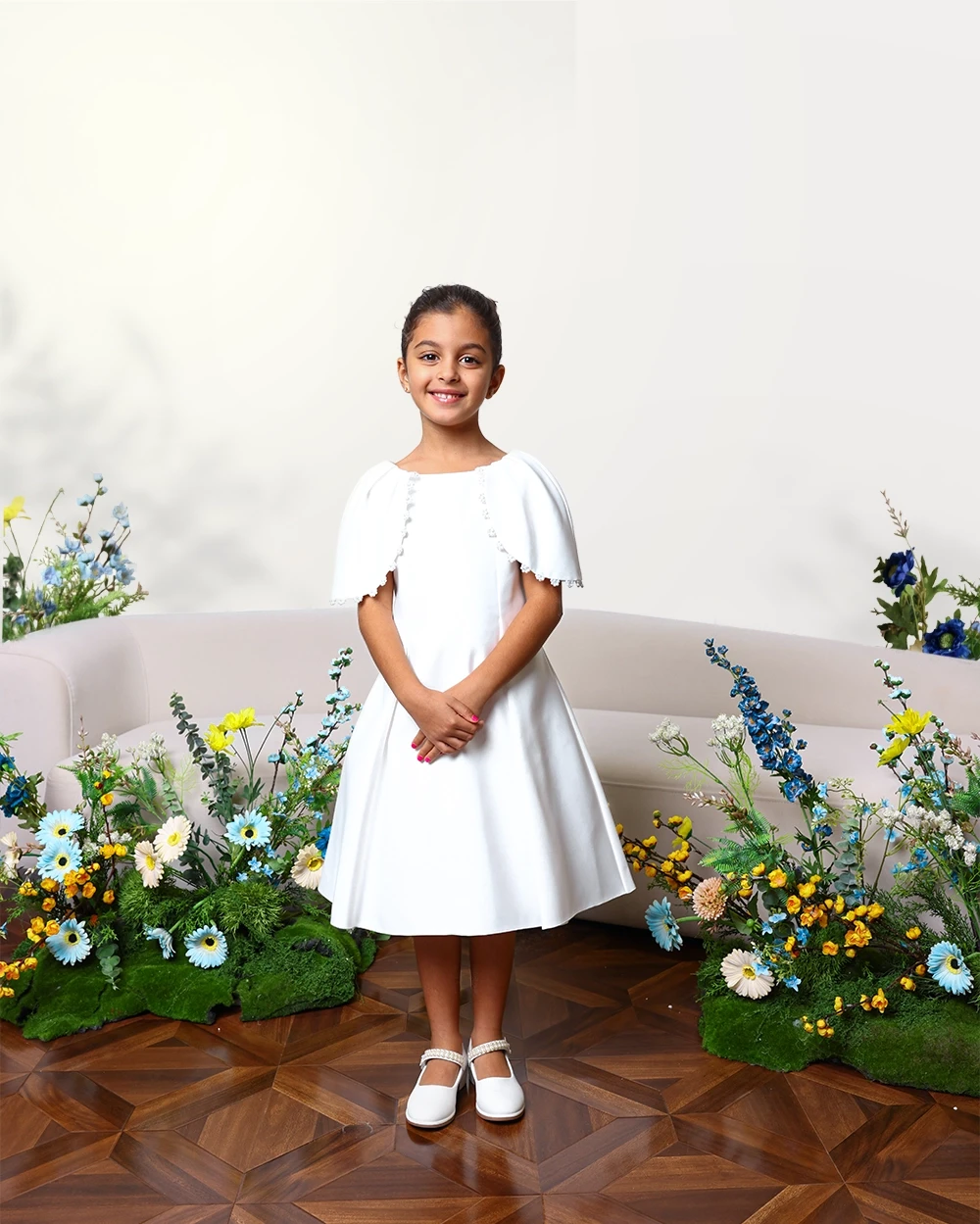 A large white bow decorates a wooden structure against a sunset.