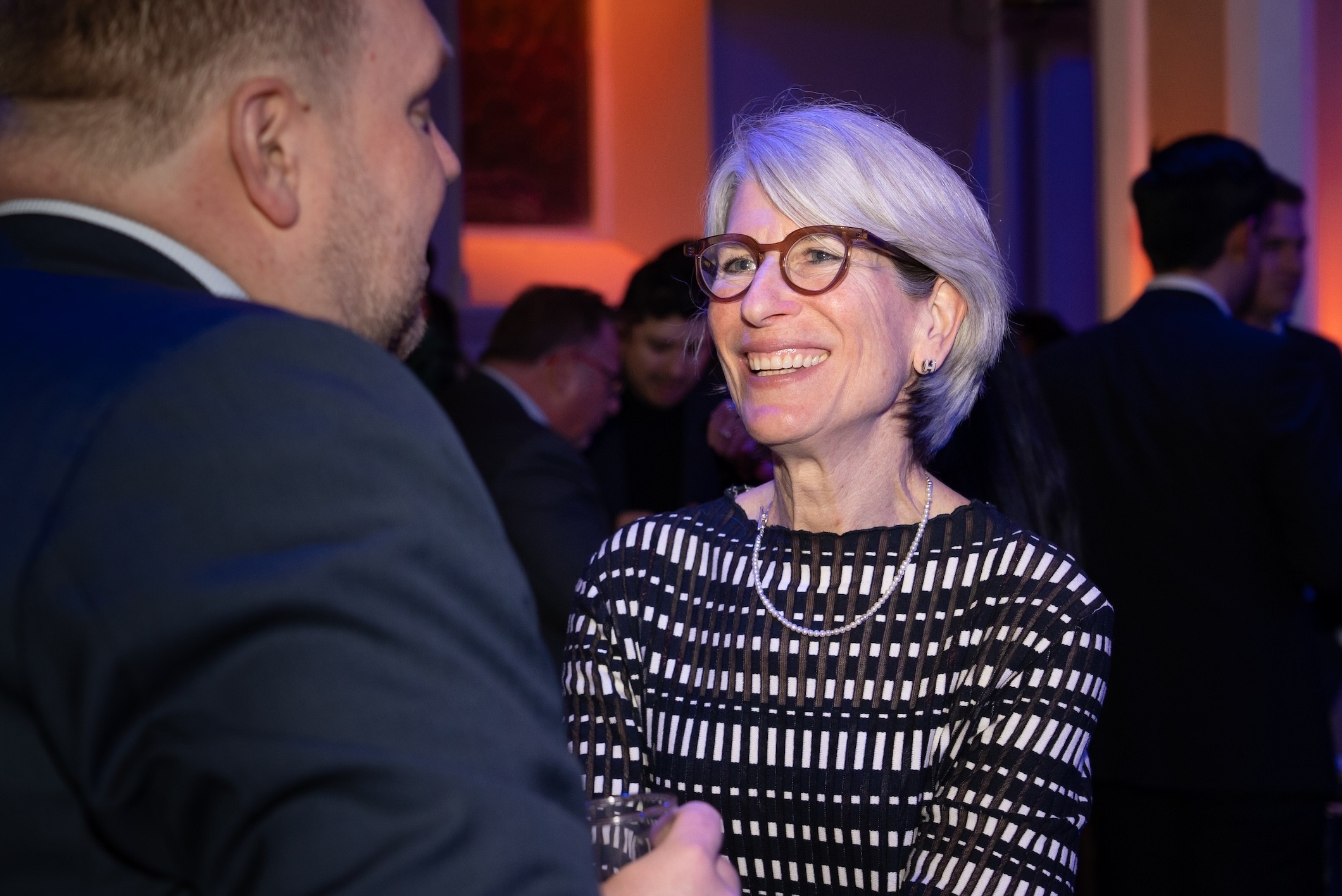 Corporate event photography of a woman smiling during the Éducaloi anniversary celebration in Montreal.