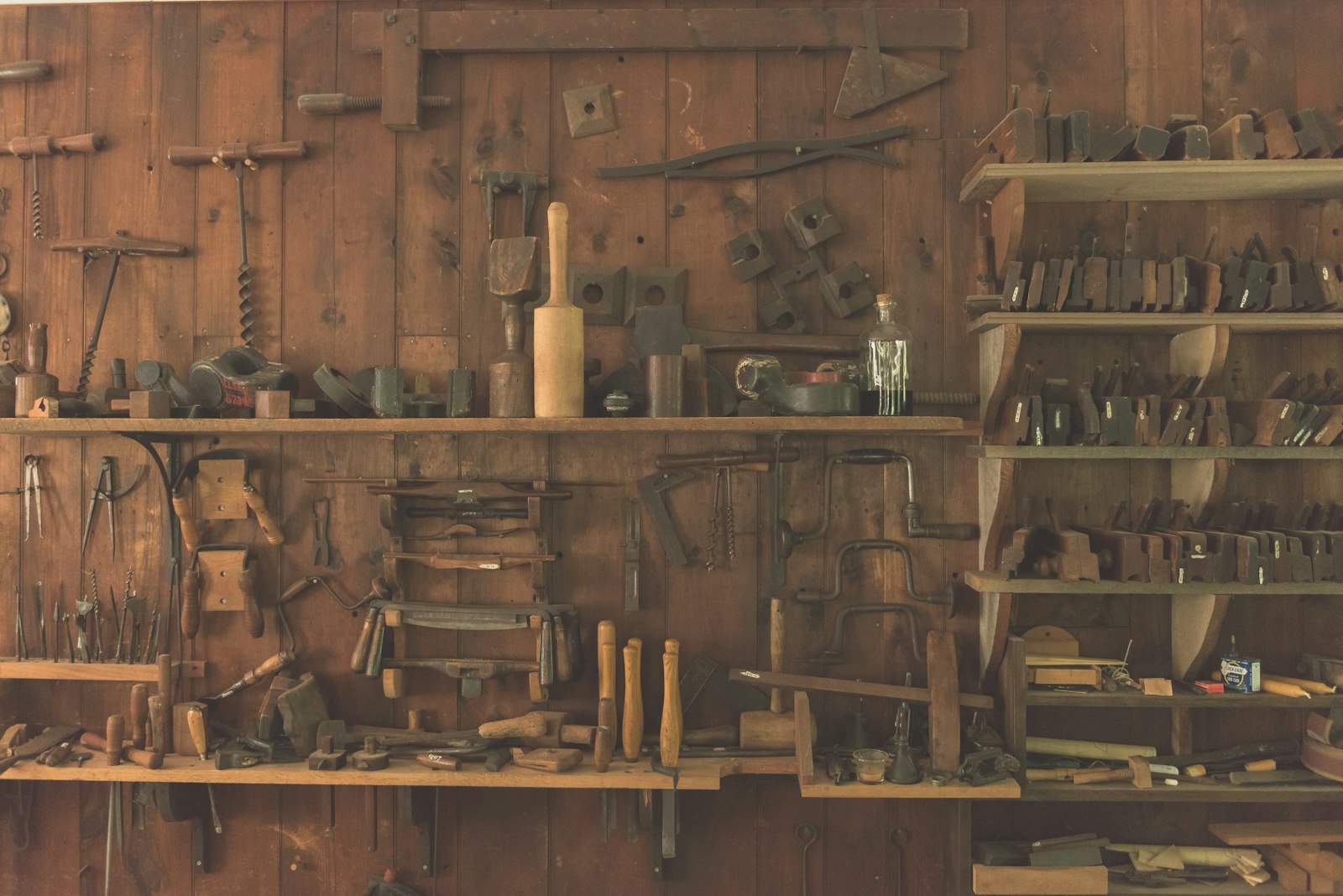 Woodworking hand tools arranged on a shelf
